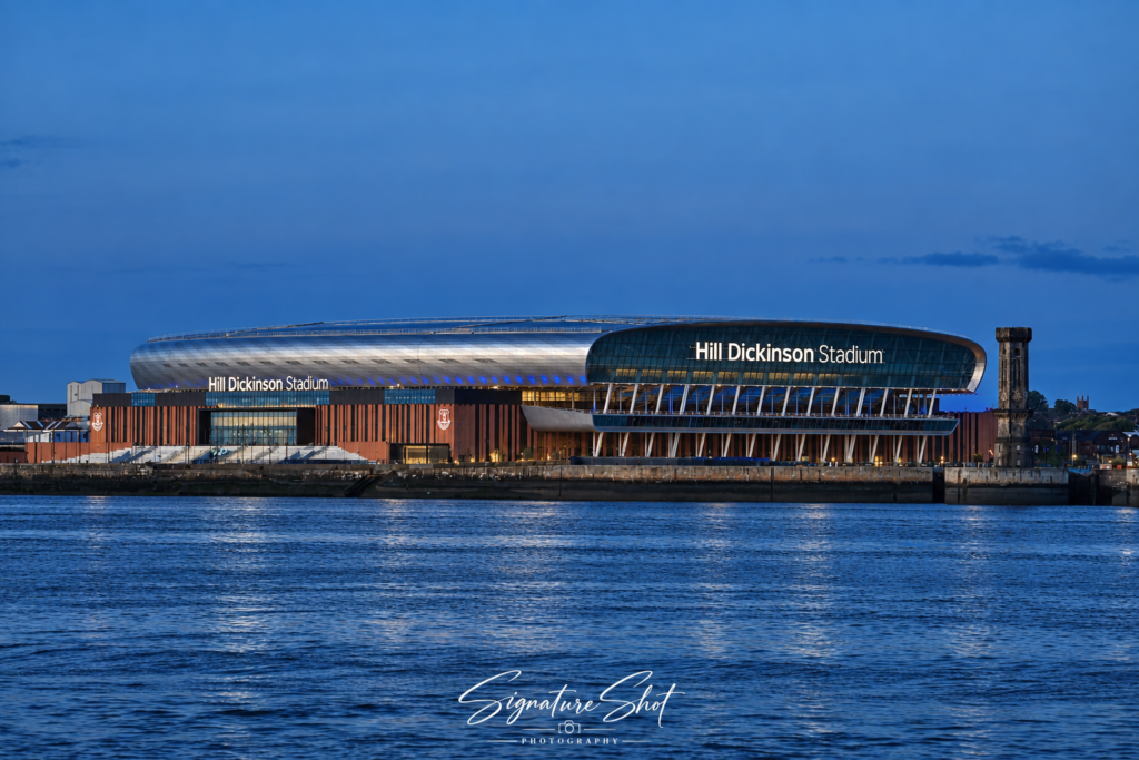 Hill Dickinson Stadium, Everton FC’s waterfront stadium, illuminated at blue hour beside the River Mersey in Liverpool.