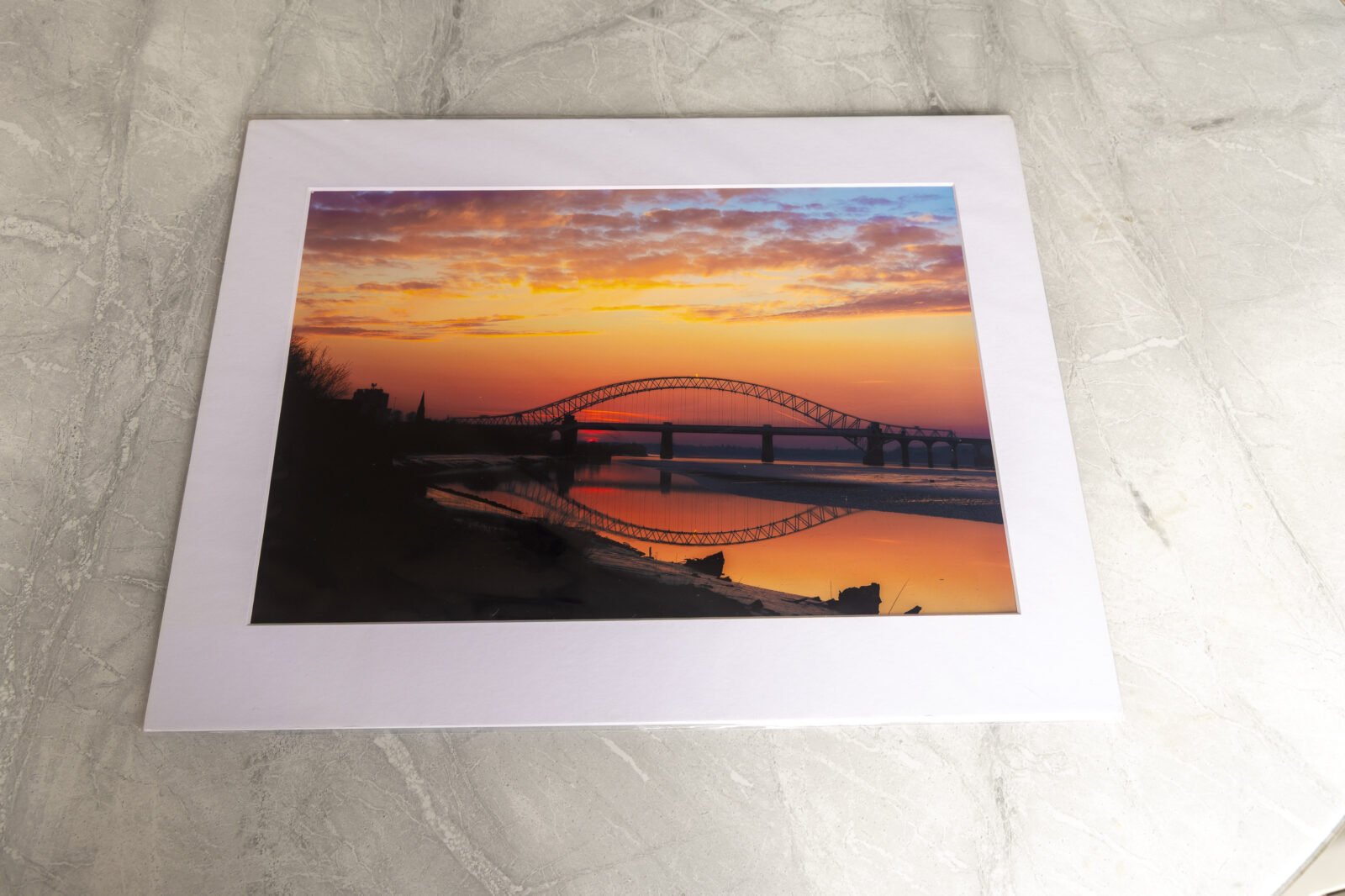 Silver Jubilee Bridge at Runcorn photographed at sunset with orange sky and reflections, presented as an A3 mounted photography print.