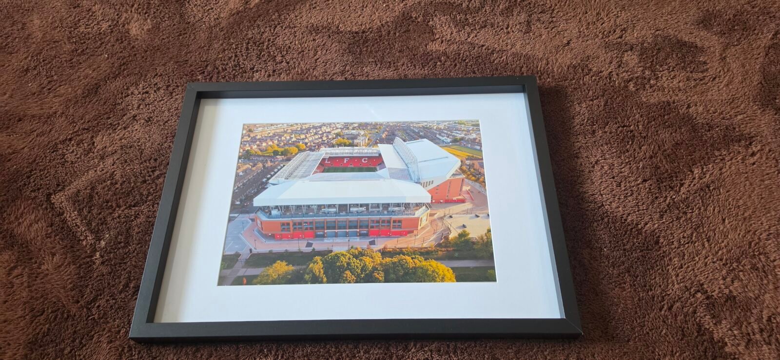 A4 framed Anfield aerial print with black frame and white mount